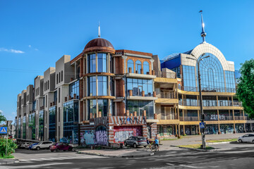 Kherson, Ukraine - July 22, 2020: Abandoned modern building of the shopping mall Suvorovsky in Kherson. Graffiti on the facade of a glass building in the city center. Urban vandalism