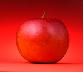 red apple on a red background.