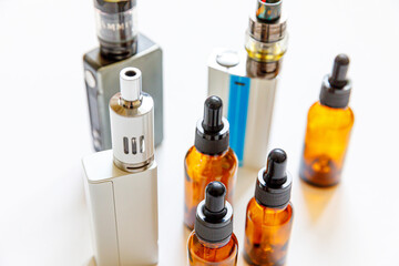 Vaping device e-cigarette electronic cigarette and liquid bottles isolated on white background....