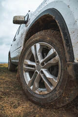 Fototapeta na wymiar suv car with dirty wheels in mud