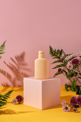 Summer style of showcase for cosmetics product display on yellow and pink background. Bottle...