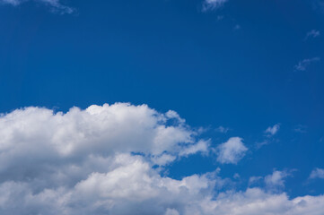 Cumulus white clouds on the blue sky