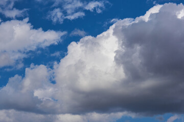 Fototapeta premium Big cumulus grey clouds on the blue sky
