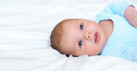 Close-up Portrait of a beautiful Baby on white. Head and Face. Newborn Baby lying on its side and...