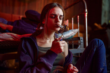 Drug addicts smokes a cigarette while high