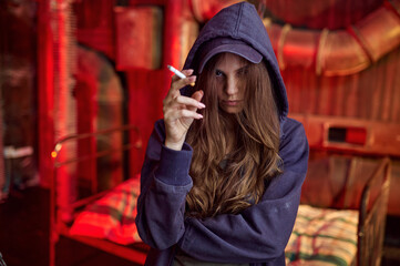 Fototapeta na wymiar Drug addict woman with cigarette in hellhole