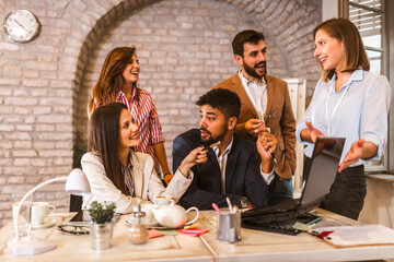 Business project team working together at meeting room at office using laptop.