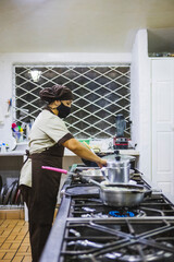 Closeup shot of a Hispanic woman making a salad with veggies