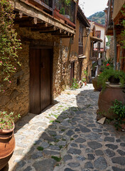 Fototapeta na wymiar The narrow stone paved street of the old Kakopetria. Nicosia District. Cyprus