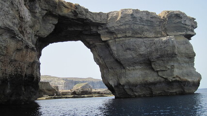 Natural rocky arch on the coast, Mediterranean landscape, rock window