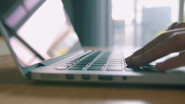 Closeup - Female hands professional user worker using typing on laptop notebook keyboard at home, working online with computer pc.