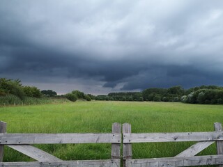 fence and clouds