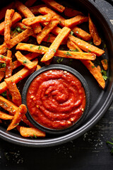 Sweet potato fries with tomato sauce, close up view