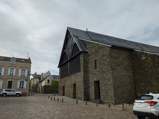 stone houses and cars parked in the courtyards