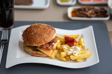 Hausgemachter Amerikanischer Käse-Burger mit goldenen Pommes frites