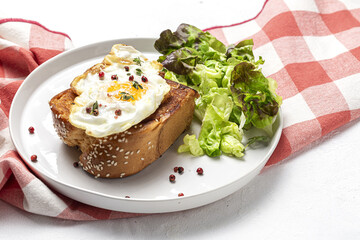 Fototapeta na wymiar Homemade Fried Eggs with Brioche and Lettuce Salad