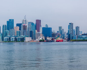 Fototapeta premium Toronto's Harbourfront and skyline seen from the beach on Ward's Island, one of chain of islands that encliose the city's Inner Harbour. 