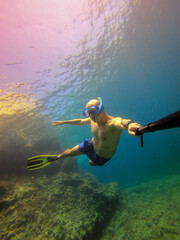 underwater man snorkeling in the sea withcrystal-clear waters concept of holiday relax summer beach diver in the sea