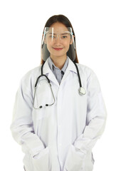 Fototapeta premium Portrait of smiling young beautiful Asian female medical doctor in lab coat with stethoscope wearing face shield, standing isolated on white background.