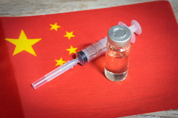 Syringe and medicine ampule on China flag.