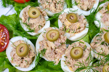 Stuffed eggs with tuna with green vegetables and olives