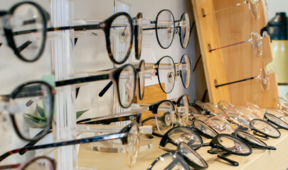 Banner, background selective focus many eyeglasses for short eyesight people put on shelves for promotion discount mid or new year sales in a retail shop for customers buying.