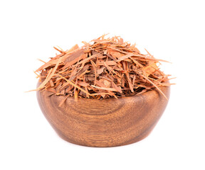 Lapacho herbal tea in wooden bowl, isolated on white background. Natural Taheeboo dry tea. Pau...