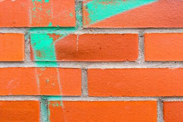 Graffiti on a red brick wall. Close-up view - obrazy, fototapety, plakaty