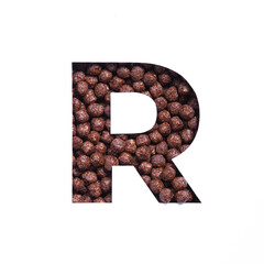 Letter R of alphabet of nutritional chocolate cereal balls, white cut paper. Typeface for healthy...