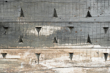 Old planked surface with triangular indentations, texture