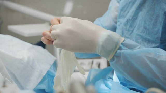 Close-up of a male surgeon wearing sterile gloves
