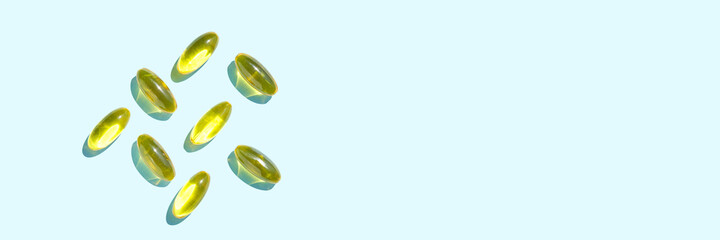 Omega3 gel capsule. Sun shadow. Yellow vitamin. Health eating. Dietology drug. Fish oil supplement. Nutritional concept. Golden softgel collagen. Medicine immunity cosmetics