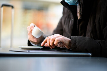 Man having coffee and using tablet