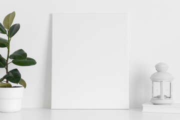 White canvas mockup with a ficus plant and a candle on the table.