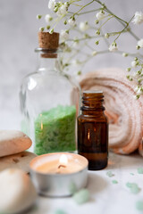Fototapeta na wymiar set of spa cosmetics: sea salt, essential oil, towel and aroma candle. vegan products, natural ingredients