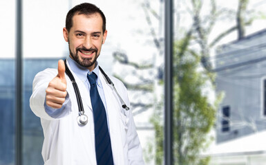 Handsome doctor portrait giving thumbs up