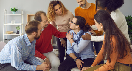 Group therapy counseling session. Diverse people psychological giving support embracing teammate. Multiethnic man and woman different age feel relief empathy help friend with problem addiction - obrazy, fototapety, plakaty