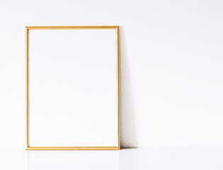 Golden frame on white furniture, luxury home decor and design for mockup, poster print and...