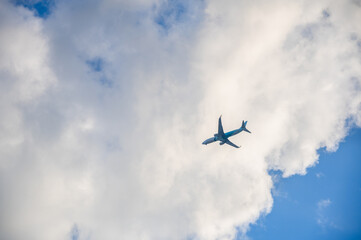 Airplane in the blue sky and clouds.