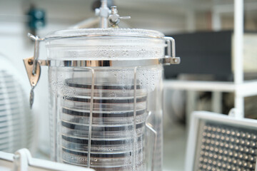Anaerobic jar full of petri plates with infrared illumination to culture Photobacterium. Anaerobic...