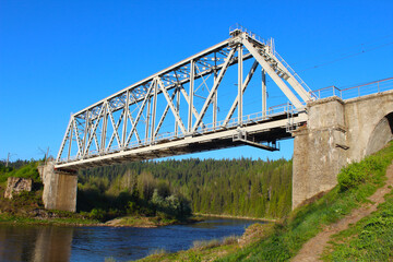 Large old metal railway bridge over the river. Close-up. Background. Scenery.
