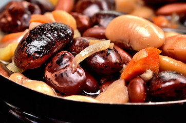 Close-up of bean soup with large beans in an old enamel pot