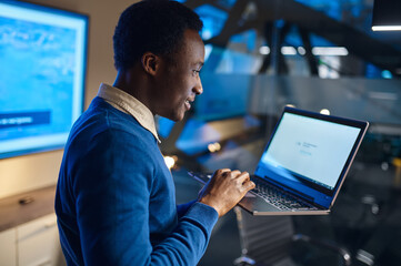 One manager works on laptop in night office