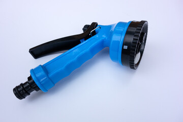 Blue nozzle for garden hose for watering beds on white isolate