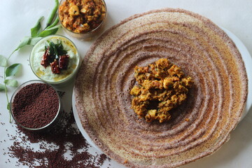 Crispy pancake made of fermented whole grain finger millet batter. Served with cottage cheese gravy in the centre of the pancake and coconut based condiment