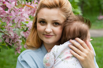 Fototapeta premium Young mother with a child in the park