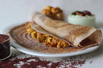 Crispy pancake made of fermented whole grain finger millet batter. Served with cottage cheese gravy in the centre of the pancake and coconut based condiment