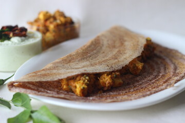 Crispy pancake made of fermented whole grain finger millet batter. Served with cottage cheese gravy in the centre of the pancake and coconut based condiment
