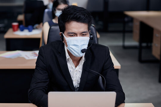 A call center agent is working with stress and thinking of something in his mind whether he will lose his job in the near future.