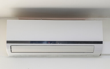 A white air heater is suspended from the ceiling